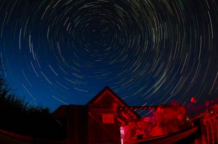 Star trails swirl above Battlesteads Hotel & Observatory, located in Northumberland, England.