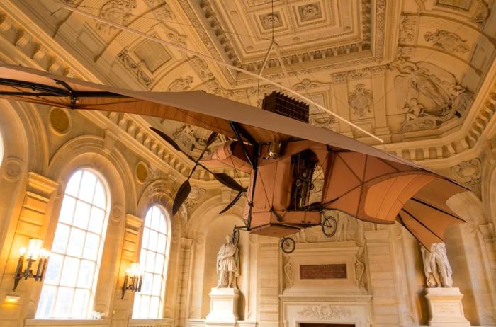 An early airplane prototype suspended from the stunning domed ceiling of the Musée des Arts et Métiers.