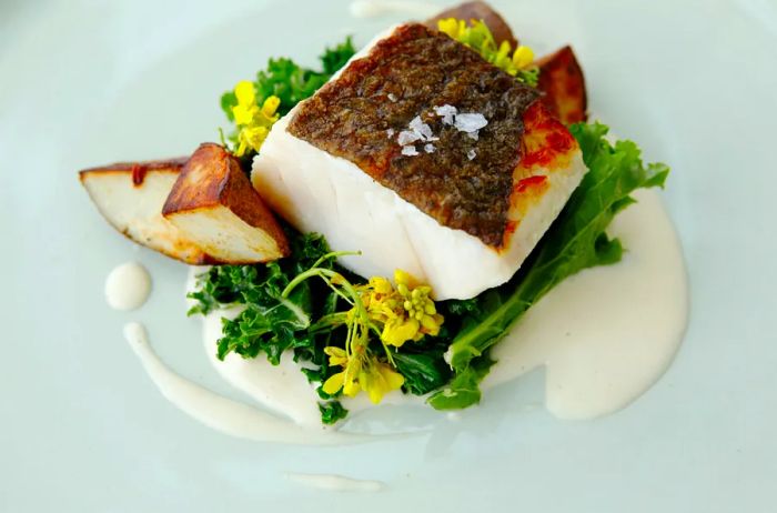 Cod served with potatoes and kale at Fogo Island Inn