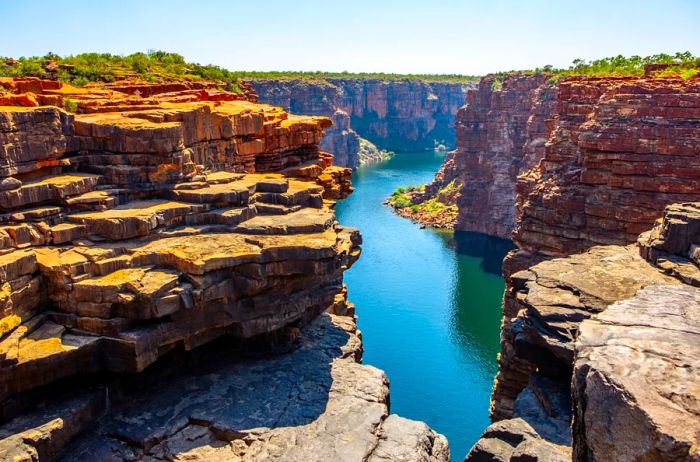 King George River Gorge in Kimberley, Australia, features a river winding through rugged sandstone cliffs.