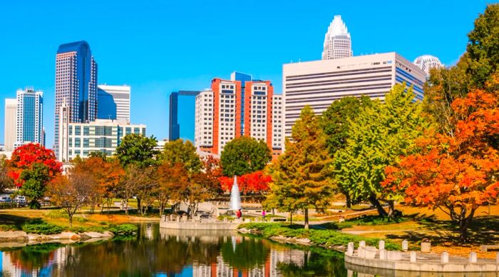 A park adorned with vibrant trees in downtown Charlotte, North Carolina, during the fall