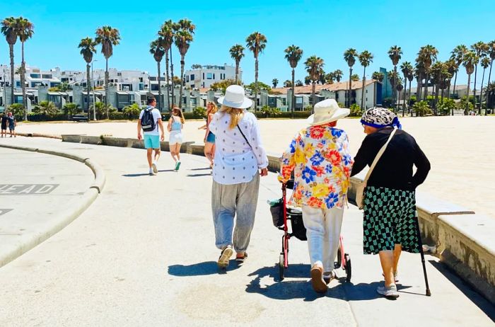 A few visitors strolling along the beach at Santa Monica