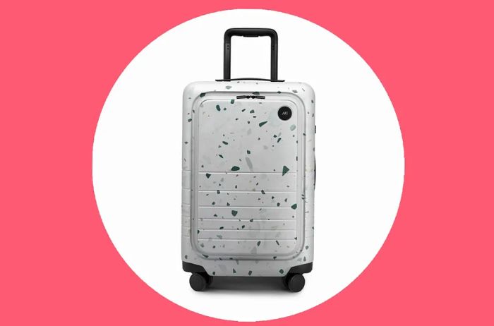 Monos Carry-On Pro Plus in white with an abstract stone print known as terrazzo