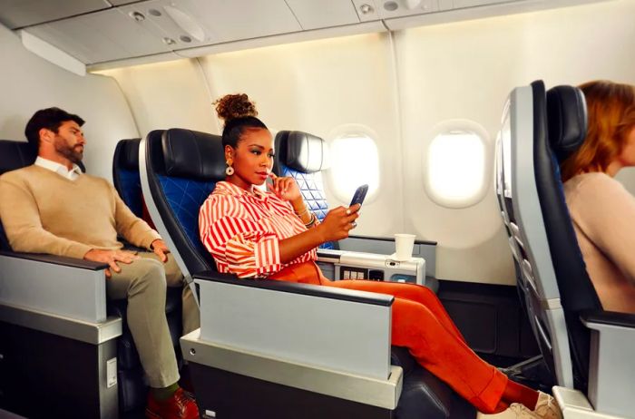 Three rows of Delta Air Lines' Premium Select seats with passengers enjoying a recline