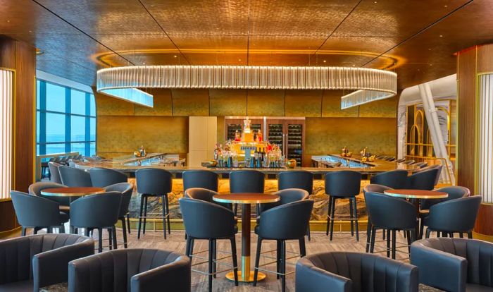 The Delta One lounge features a stylish bar with blue high chairs around round bar tables and a U-shaped bar.