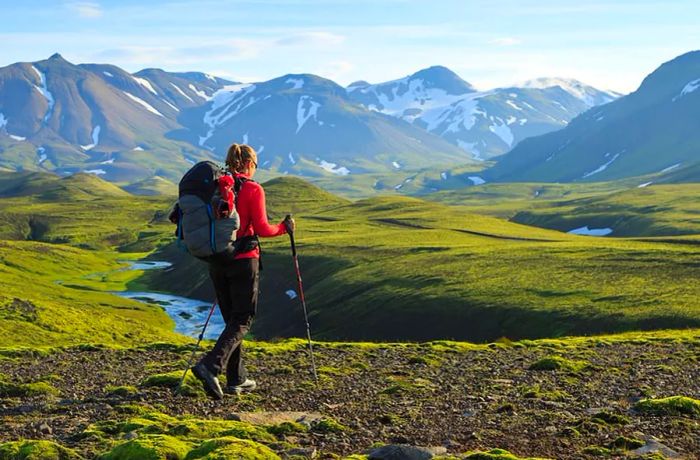 A woman hiking and enjoying the Icelandic scenery