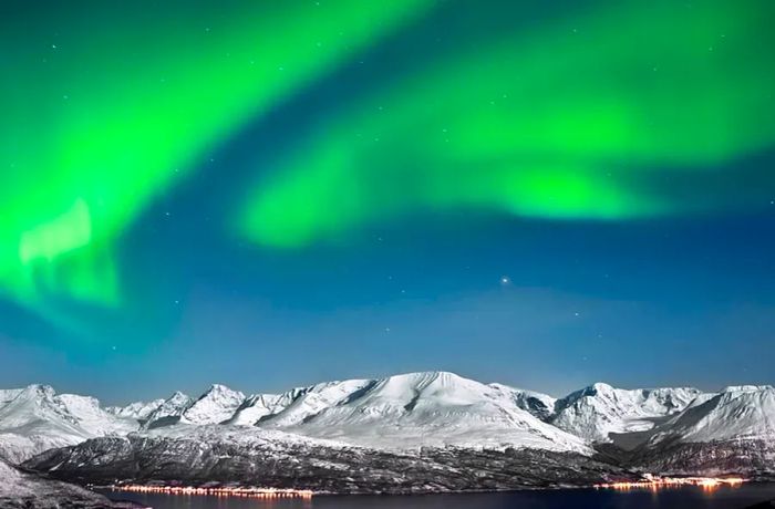 Auroras illuminating the fjords near the Arctic Circle