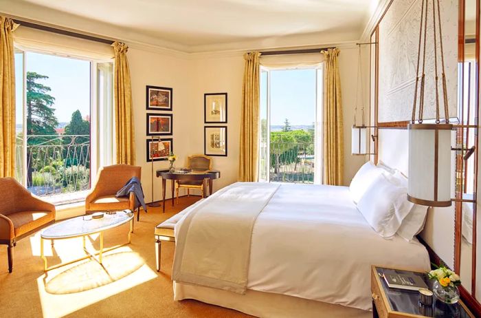 The guest rooms at Hotel Eden feature expansive floor-to-ceiling windows, private balconies, and a soothing neutral color scheme.