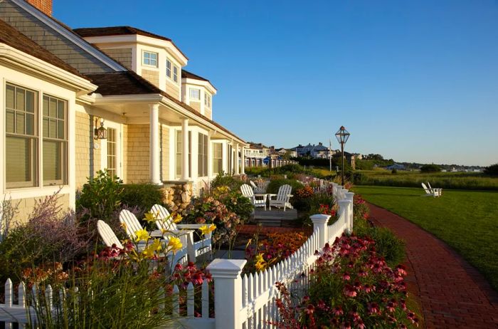 The facade of a beige and white cottage at Chatham Bars Inn located in Cape Cod, Massachusetts.