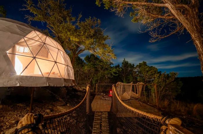 The exterior of a Ukiyo dome at the Missing Hotel, illuminated at night.