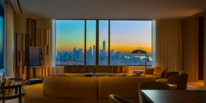 A living room in one of the Ritz Carlton NoMad residences boasts a view of the city skyline.