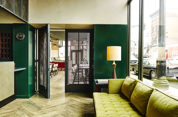 The lobby of the Robey Chicago features a midcentury-modern design, enhanced by vibrant green accents.