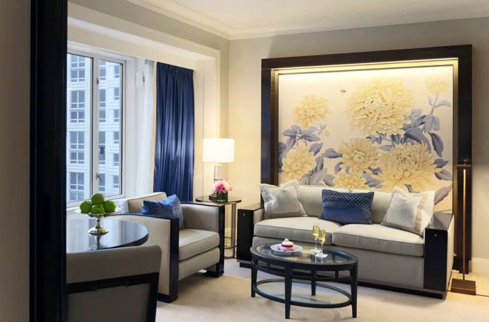 The guest room at Peninsula Chicago showcases a palette of gray complemented by large floral artwork.