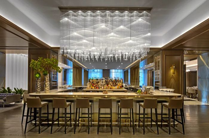 The bar at Adorn Bar & Restaurant, featuring a stunning large glass chandelier