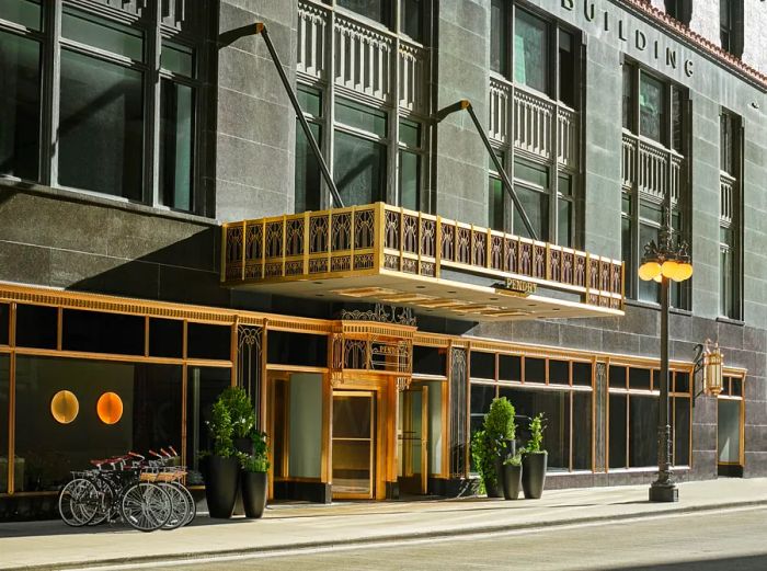 The art deco facade of Pendry Chicago, highlighted with gold accents.