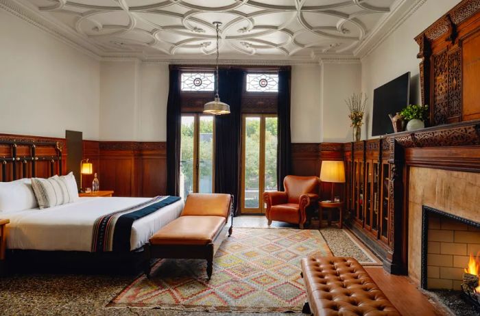 Interior of the Founders Suite at the Chicago Athletic Association, featuring a charming stone fireplace