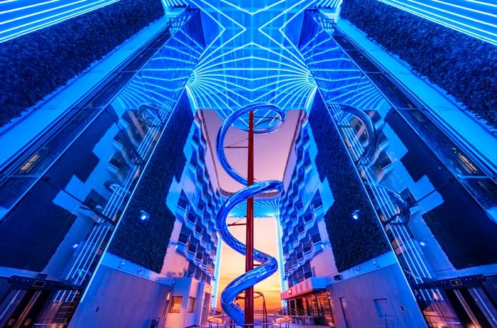 A breathtaking view of an 11-story slide on a cruise ship, captured from a low angle during sunset.