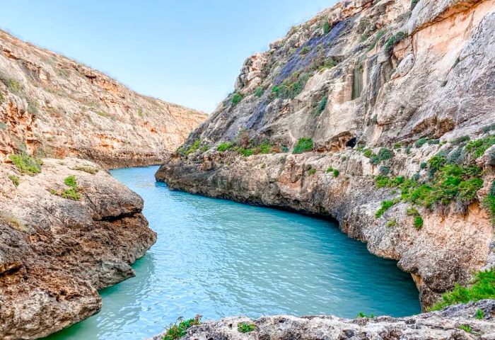 Wied il-Għasri is a serene canyon perfect for hiking and swimming along Gozo's northern coast.