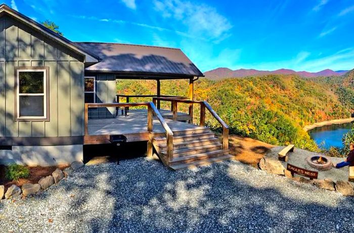 View of a cabin near Bryson City, North Carolina, complete with a wooden deck and surrounded by forested hills