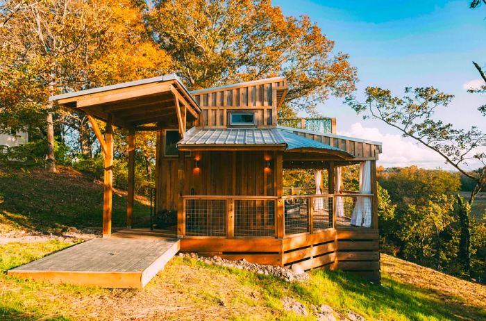 Exterior view of a cozy wooden house with a deck