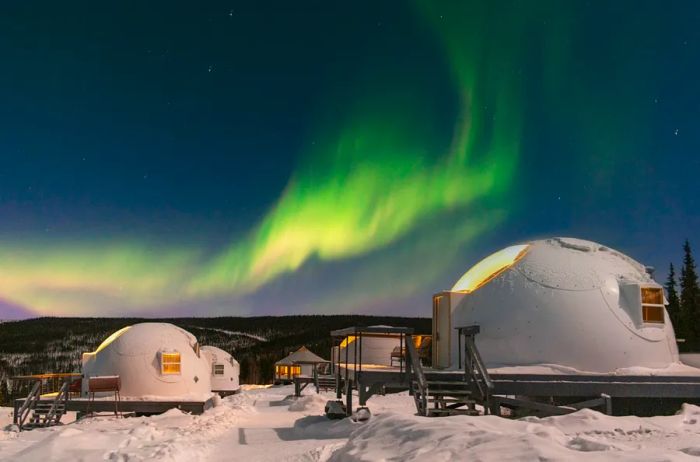 Glass-domed igloos at Borealis Basecamp under the northern lights