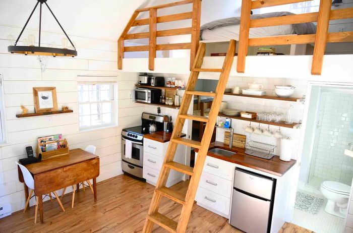 Farmhouse-style Airbnb cabin featuring a ladder leading up to a cozy sleeping loft