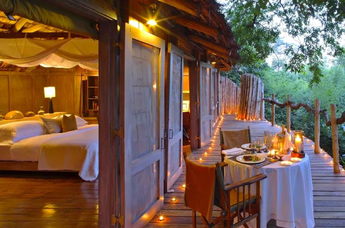 Tree house suite at andBeyond Lake Manyara Tree Lodge featuring a private dinner setup on the balcony