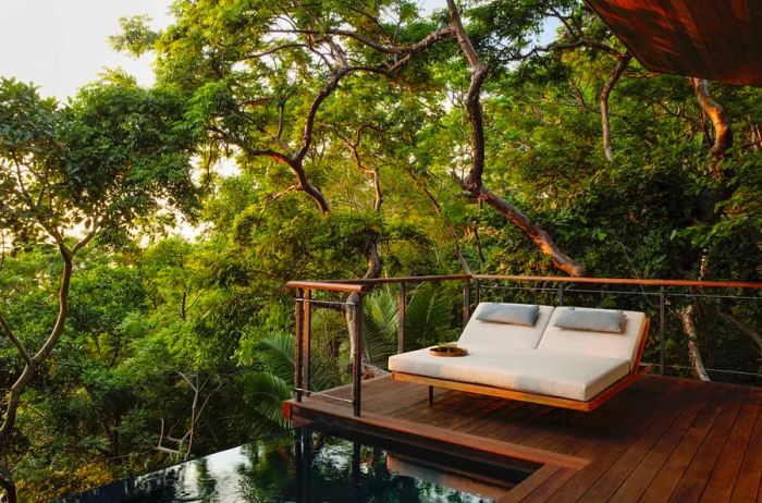 Private plunge pool with deck chair amidst the jungle canopy at One&Only Mandarina