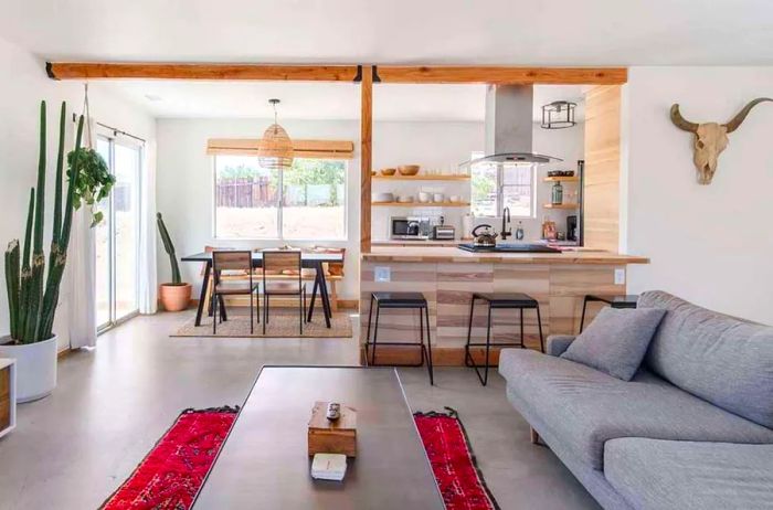 Cozy interior showcasing a gray sofa with the kitchen visible in the background