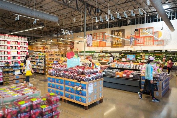 Shoppers explore the produce section at Whole Foods Market in Dublin, California, on June 16, 2017. On this date, Amazon.com announced its intention to acquire the upscale grocery chain. (Photo by Smith Collection/Gado/Getty Images).