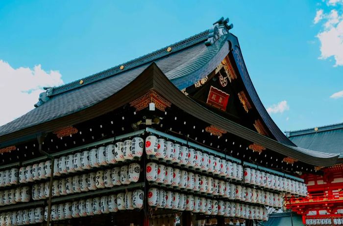The historic Yasaka Shrine, located in Kyoto's Gion district, is adorned with three tiers of hanging white lanterns and has stood for over 1,300 years.