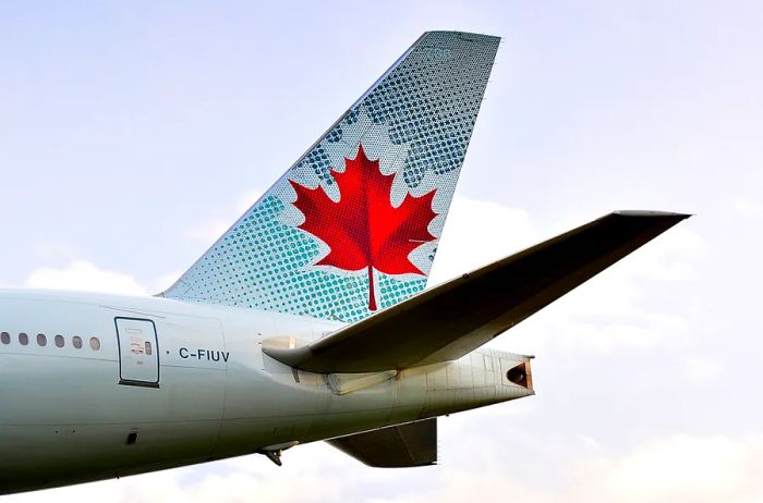Tail of an Air Canada aircraft featuring the iconic red maple leaf design