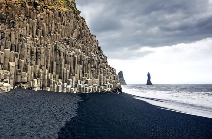 The black-sand beach of Reynisfjara and Mount Reynisfjall as seen from the Dyrholaey promontory on Iceland's southern coast