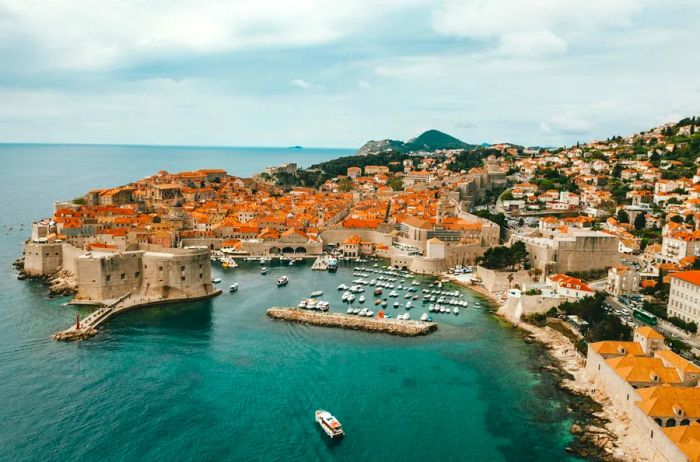 An aerial perspective of the coastal Old Town Dubrovnik, showcasing its small harbor