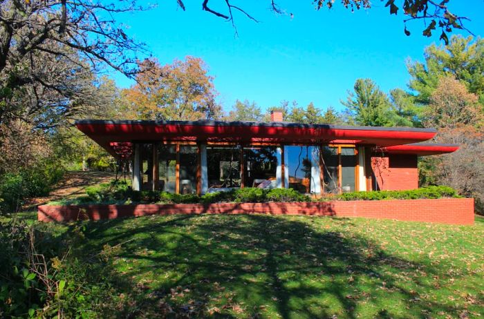 Cedar Rock house shaded by a tree near the Wapsipinicon River.