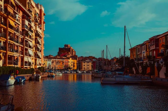 Colorful buildings line the waterfront, adorned with sailboats in Valencia.