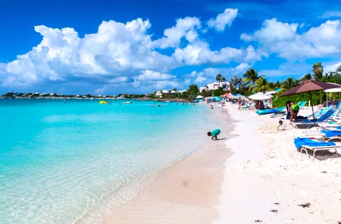Families love the soft white sands and crystal-clear Caribbean waters of Sapodilla Bay Beach in the Turks and Caicos Islands.