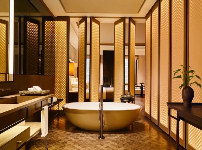 All suite bathrooms at Aman New York feature heated floors and spacious freestanding bathtubs.