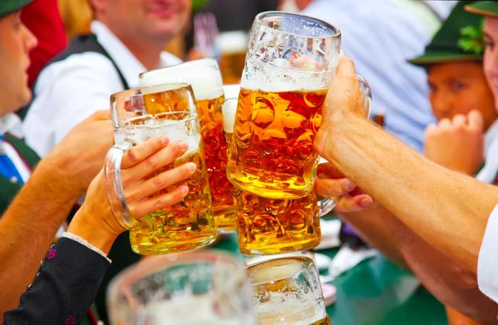 Beer lovers at Oktoberfest raise their steins in celebration.