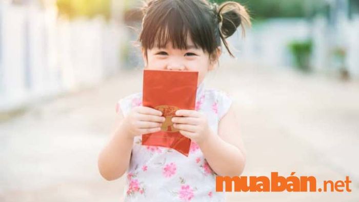 Bé gái xinh xắn tạo dáng chúc xuân dễ thương với bao lì xì