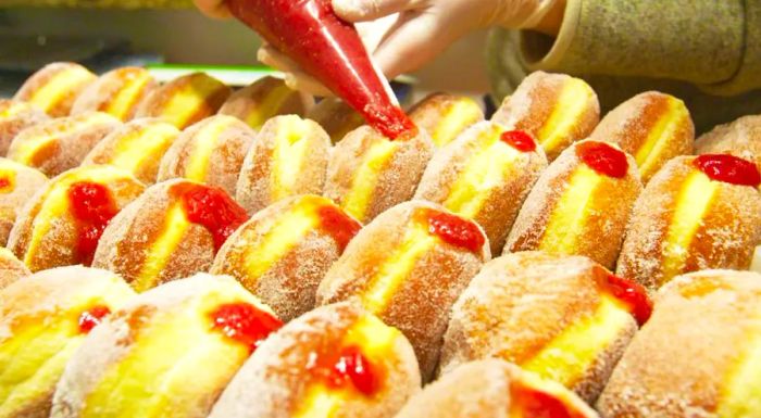 Carolyn Nugent fills Berliner donuts with homemade berry preserves. She and her husband are set to open a permanent bakeshop in the suburbs this summer.