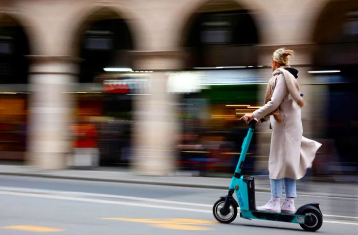 A woman rides a shared electric scooter in Paris on April 1.