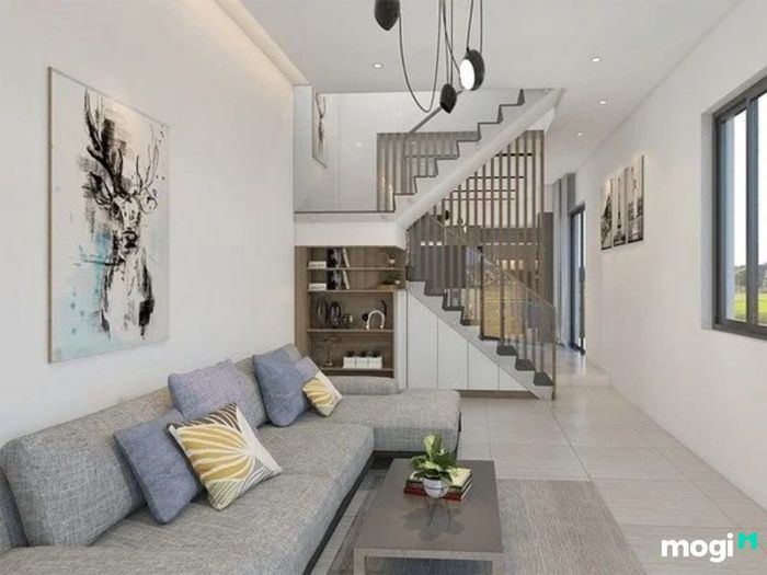 Phòng khách với sofa chữ L màu xám, thiết kế đơn giản nhưng tinh tế.