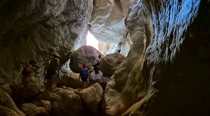 A final scramble through a cave-like chamber leads to a stunning waterfall.