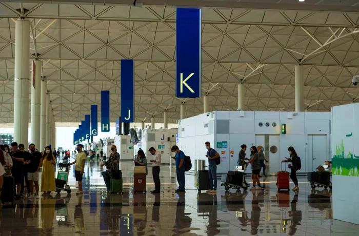 Travelers at Hong Kong International Airport's departure hall on September 26.