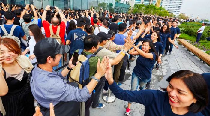 Apple reports that hundreds camped overnight to be among the first to visit its new store in Thailand.