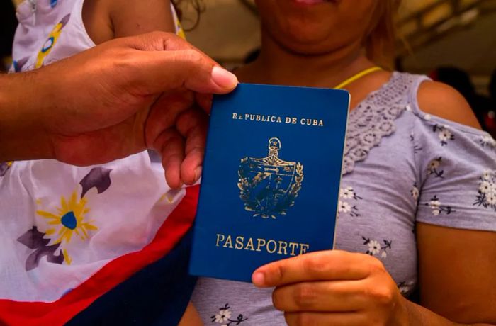 A Cuban migrant displays her Cuban passport in Colombia.