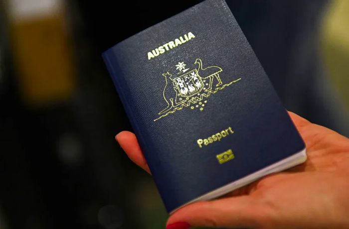 A traveler shows an Australian passport while checking in for a flight to Sydney at Los Angeles International Airport.