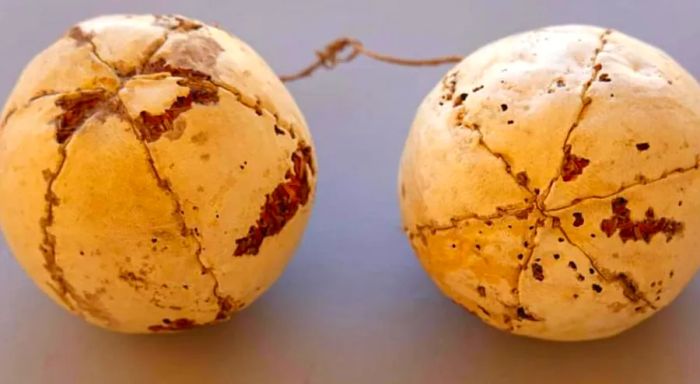 Nearby, a pair of leather balls were found, tied together with thread.