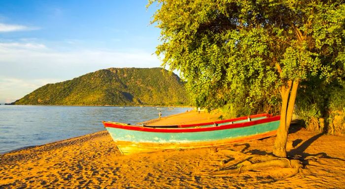 A boat rests on the shore of Lake Malawi at Cape Maclear in Malawi, located in southern Africa.